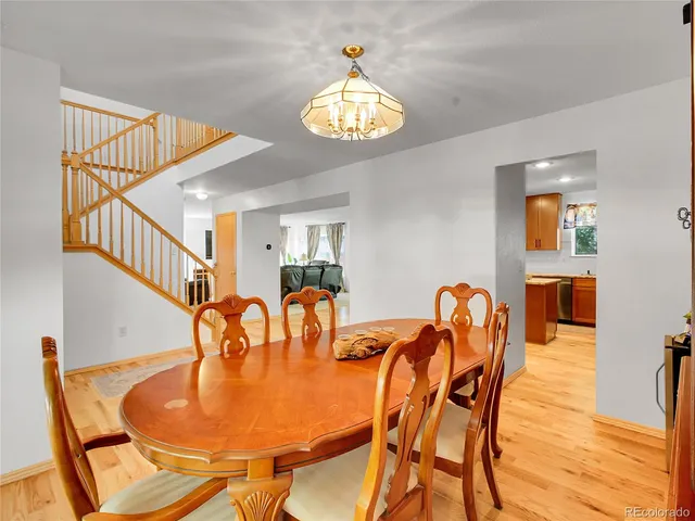 a dining room with furniture and a chandelier