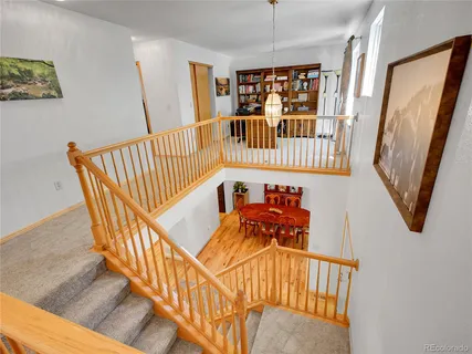 a spacious bedroom with a bed chandelier and a window