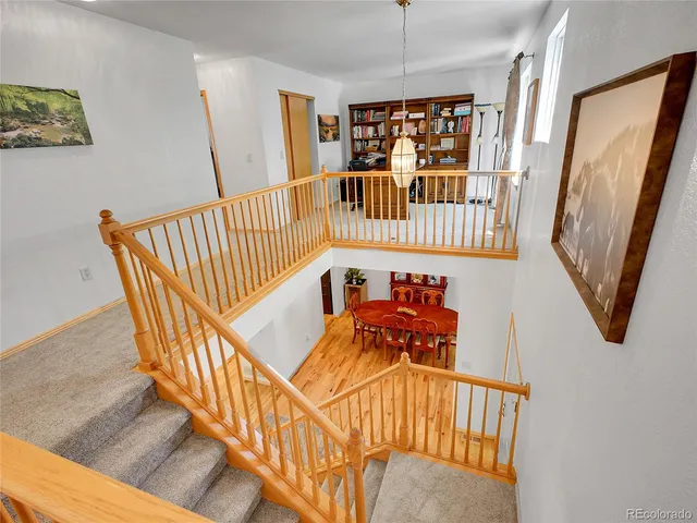 a spacious bedroom with a bed chandelier and a window