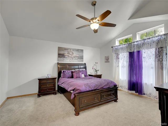a bedroom with a bed dresser and window