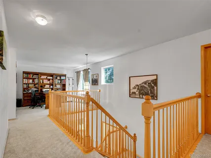 a view of a workspace with furniture and a window