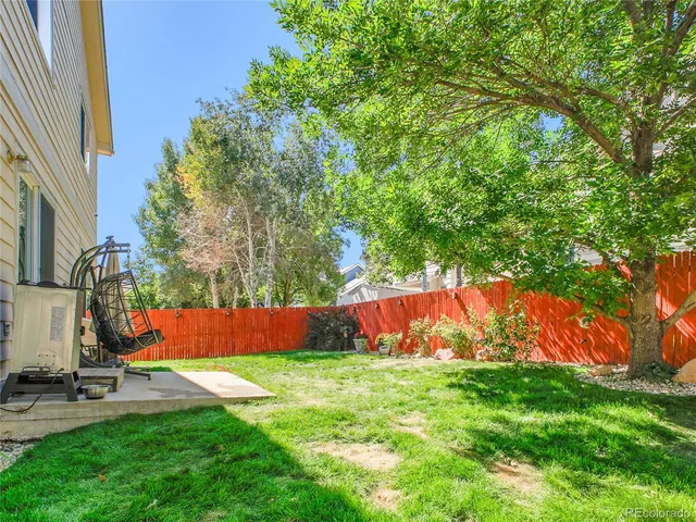 a view of backyard with swimming pool and outdoor seating