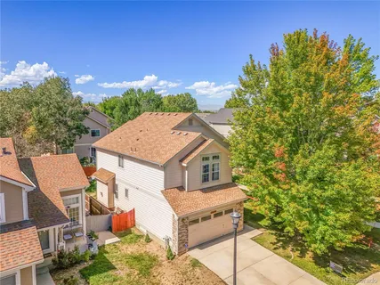 an aerial view of residential houses with outdoor space and ocean view