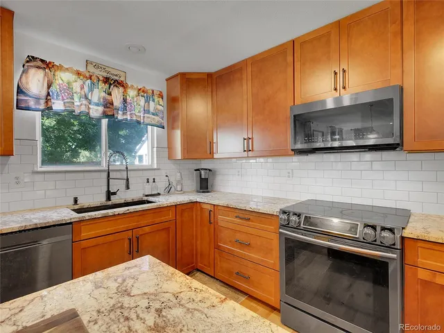a kitchen with a sink stove and microwave