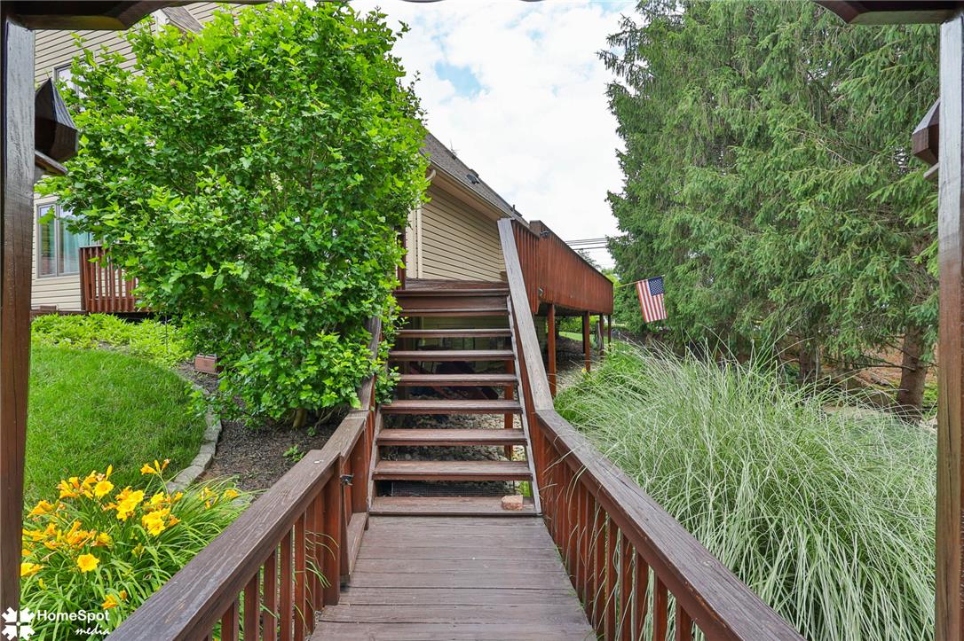 2821 Center Street Bethlehem, PA 18017 - Photo 66 of 68 A rustic wood deck and stairs lead to a verdant outdoor sanctuary, ideal for private enjoyment.