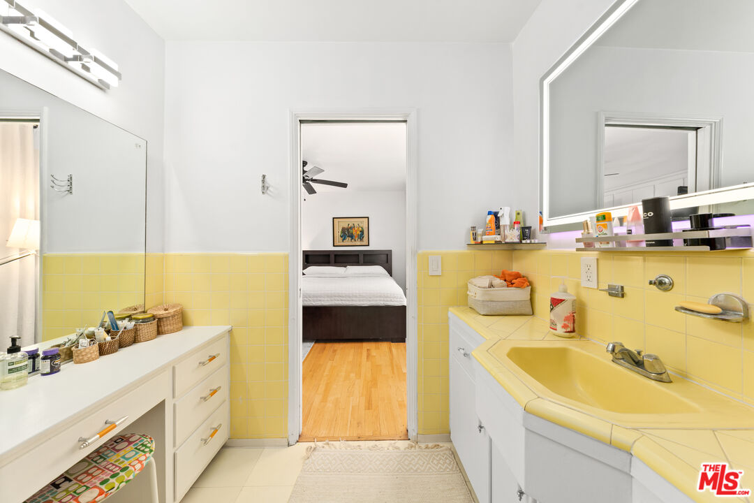 1330 North Crescent Heights Boulevard, Unit 16 West Hollywood, CA 90046 - Photo 12 of 25 a bathroom with a tub sink and mirror