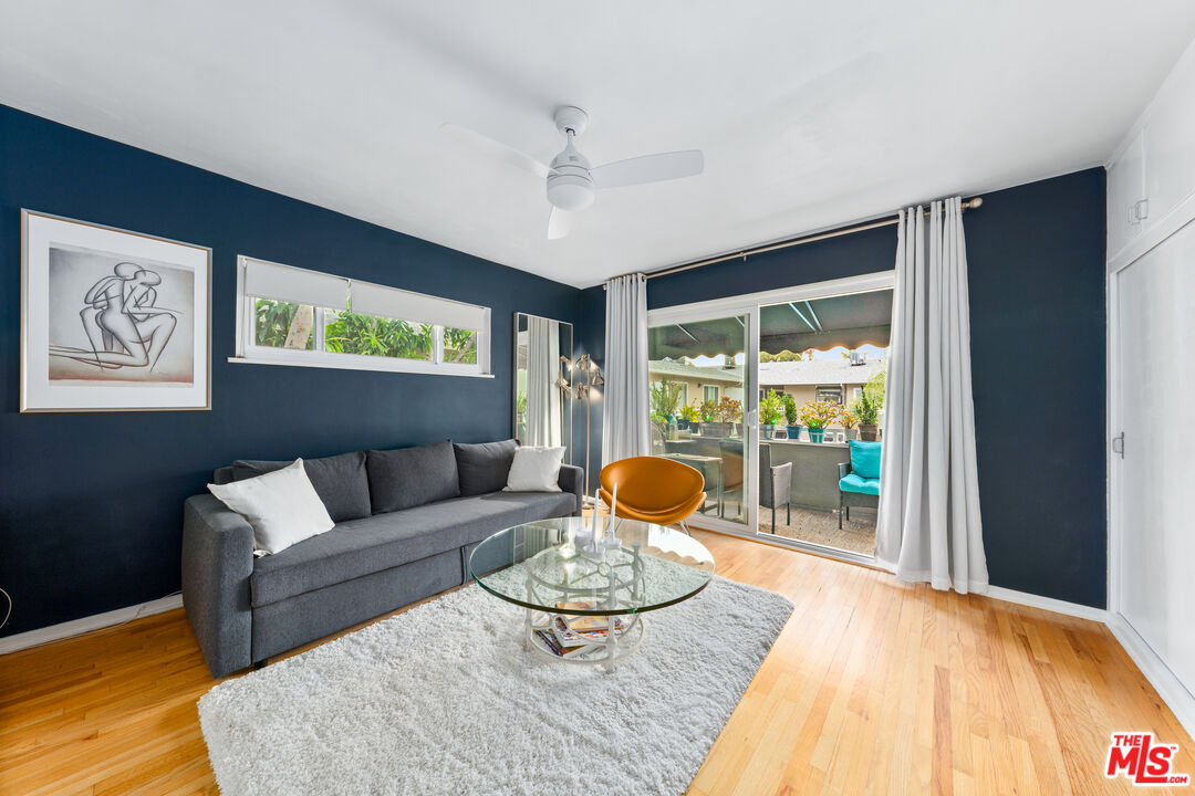 1330 North Crescent Heights Boulevard, Unit 16 West Hollywood, CA 90046 - Photo 13 of 25 a living room with furniture and a large window