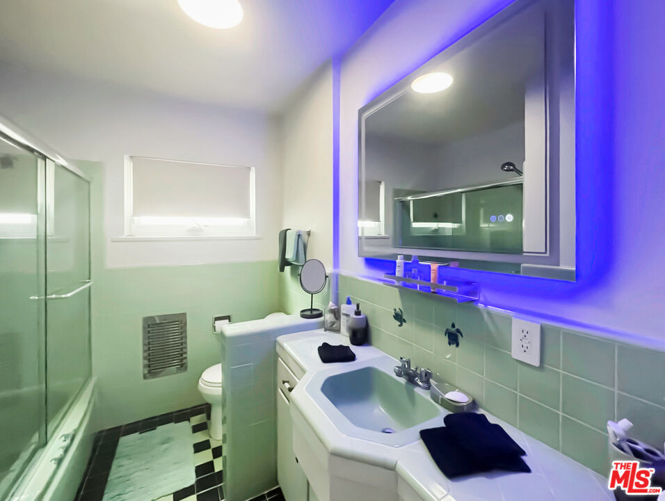 1330 North Crescent Heights Boulevard, Unit 16 West Hollywood, CA 90046 - Photo 15 of 25 a bathroom with a sink mirror and toilet