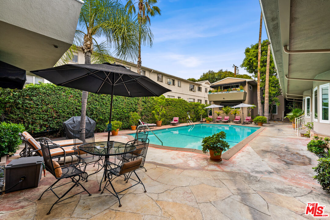 1330 North Crescent Heights Boulevard, Unit 16 West Hollywood, CA 90046 - Photo 19 of 25 a view of a chairs and table in backyard