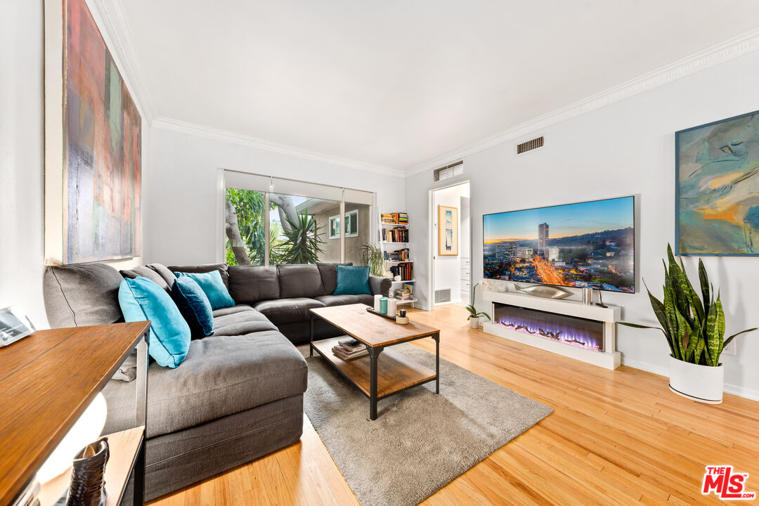 1330 North Crescent Heights Boulevard, Unit 16 West Hollywood, CA 90046 - Photo 2 of 25 a living room with furniture and a flat screen tv