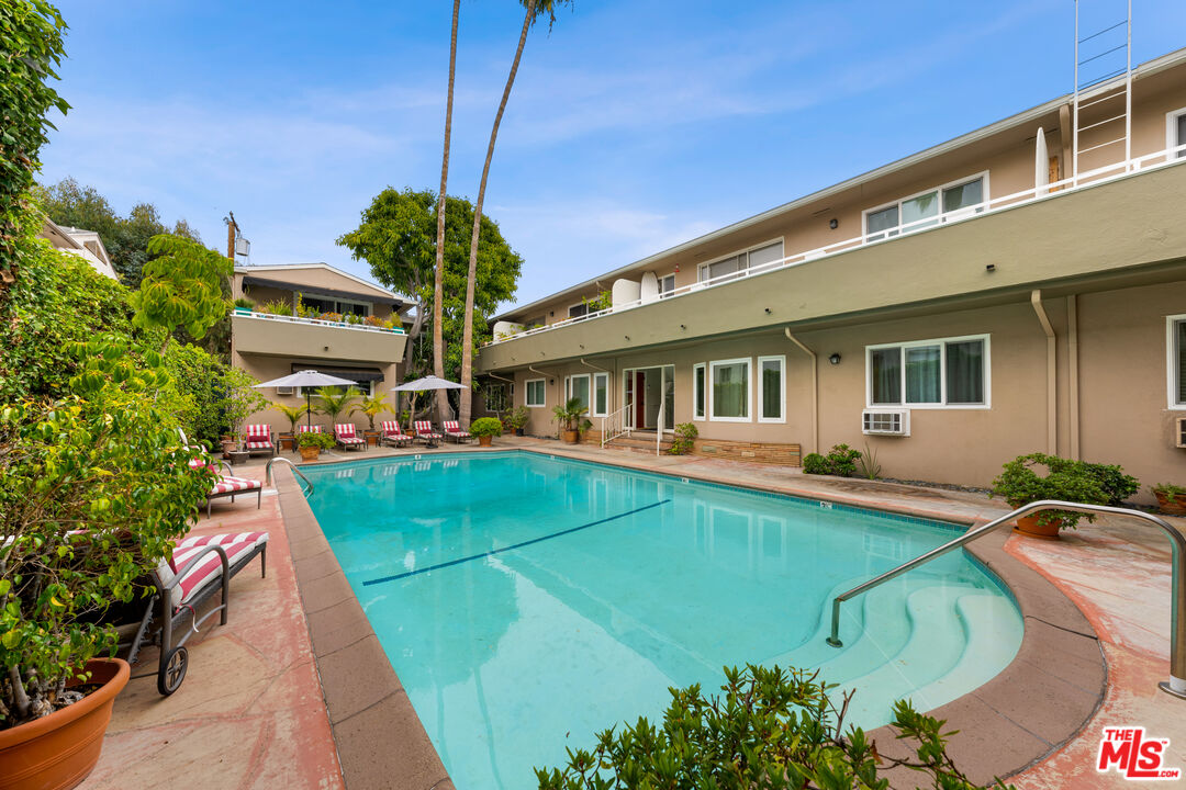 1330 North Crescent Heights Boulevard, Unit 16 West Hollywood, CA 90046 - Photo 21 of 25 a front view of a house with swimming pool