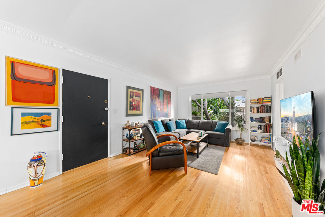 1330 North Crescent Heights Boulevard, Unit 16 West Hollywood, CA 90046 - Photo 3 of 25 a living room with furniture and a flat screen tv