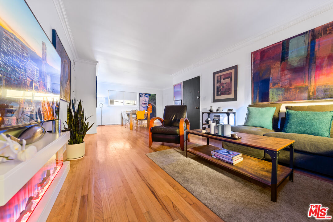 1330 North Crescent Heights Boulevard, Unit 16 West Hollywood, CA 90046 - Photo 4 of 25 a living room with furniture and a wooden floor