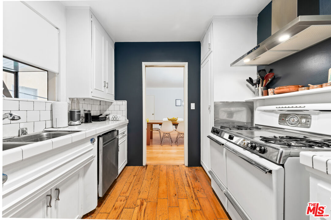 1330 North Crescent Heights Boulevard, Unit 16 West Hollywood, CA 90046 - Photo 9 of 25 a kitchen with stainless steel appliances granite countertop a stove and a sink