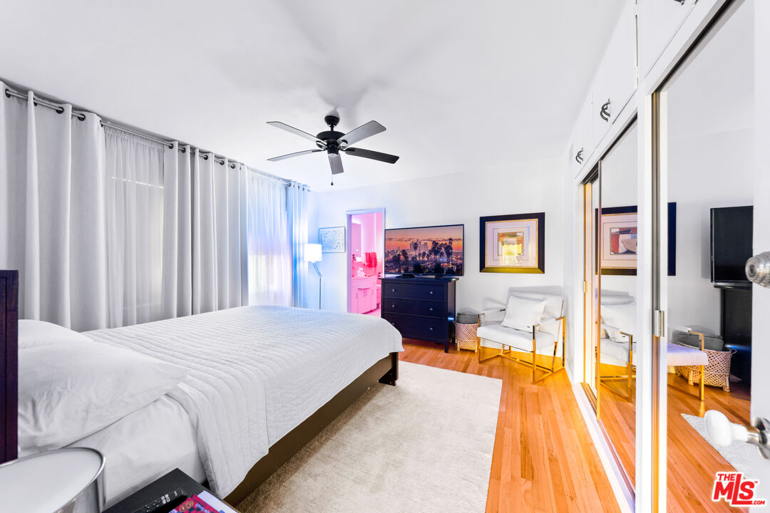 1330 North Crescent Heights Boulevard, Unit 16 West Hollywood, CA 90046 - Photo 10 of 25 a spacious bedroom with a bed and a chandelier