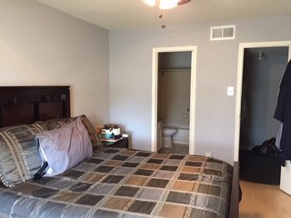 8787 Brae Acres Road, Unit 403 Houston, TX 77074 - Photo 5 of 7 a bedroom with a bed and a mirror
