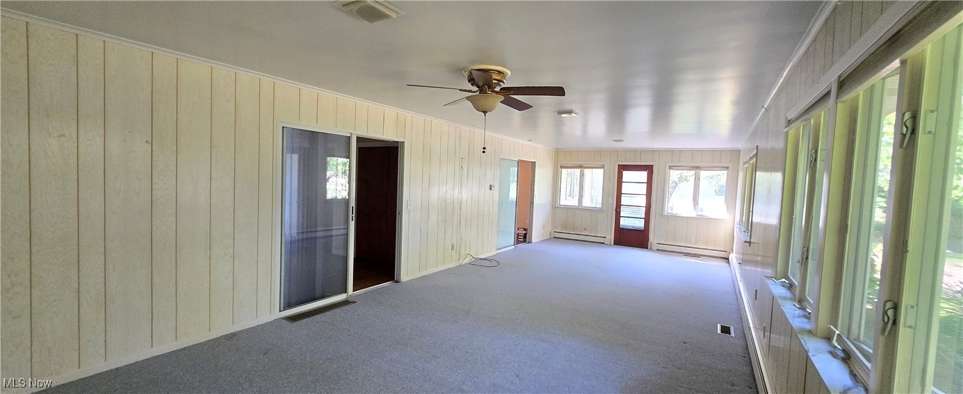 2707 Merriweather Road Sandusky, OH 44870 - Photo 16 of 28 Unfurnished sunroom featuring ceiling fan and a baseboard radiator