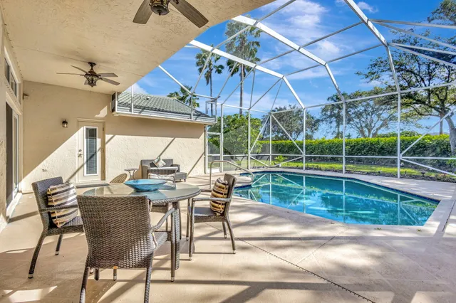 a view of a patio with a table and chairs