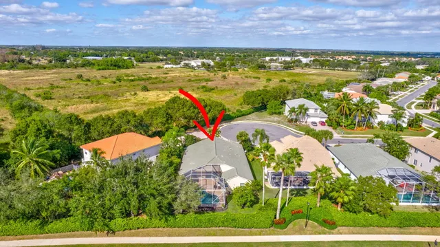 an aerial view of a house with a swimming pool yard and outdoor seating