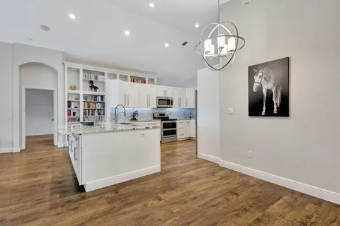 a view of kitchen with sink and wooden floor