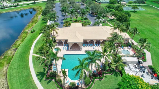 an aerial view of a house with a yard basket ball court and outdoor seating