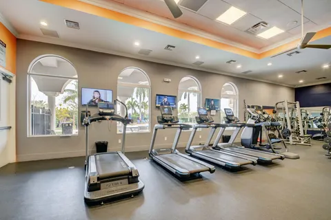 a room with gym equipment and large mirror