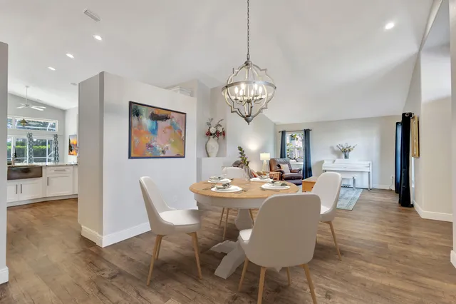 a view of a dining room with furniture wooden floor and chandelier