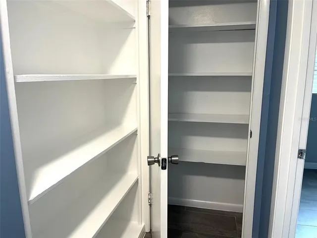 a view of walk in closet with empty racks