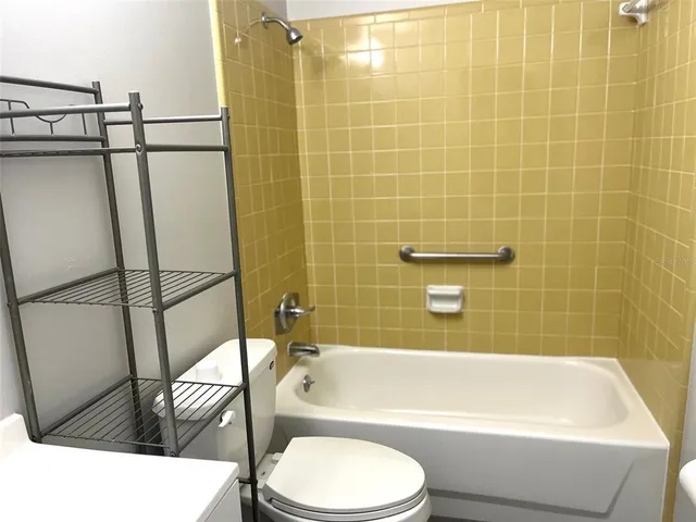 a bathroom with a sink a toilet and bathtub