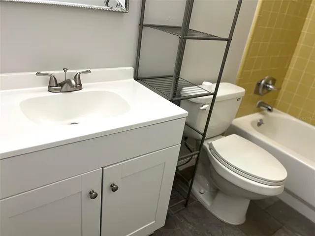 a white toilet sitting next to a bathroom sink