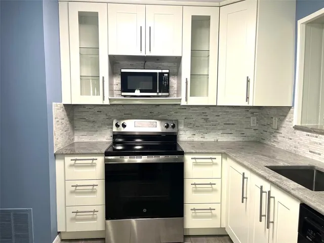a kitchen with a stove and a microwave