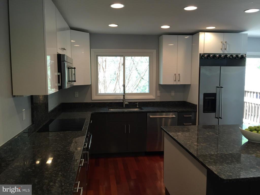 9042 Saffron Lane Silver Spring, MD 20901 - Photo 8 of 21 a kitchen with granite countertop sink stove and cabinets