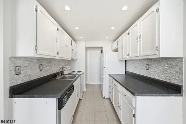 a kitchen with a sink and a stove top oven