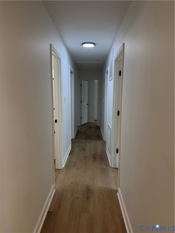 8207 Sebera Road Prince George, VA 23875 - Photo 17 of 27 Hallway featuring wood-finish flooring, light neut