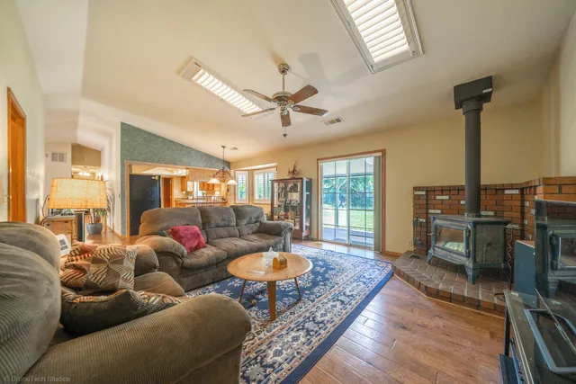 a living room with furniture a ceiling fan and a rug