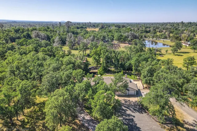 an aerial view of a house with yard and outdoor seating