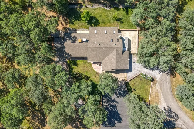 an aerial view of a house with outdoor space pool seating area and yard