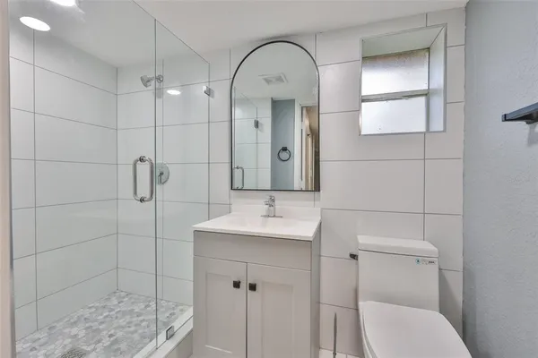 a bathroom with a sink toilet and shower