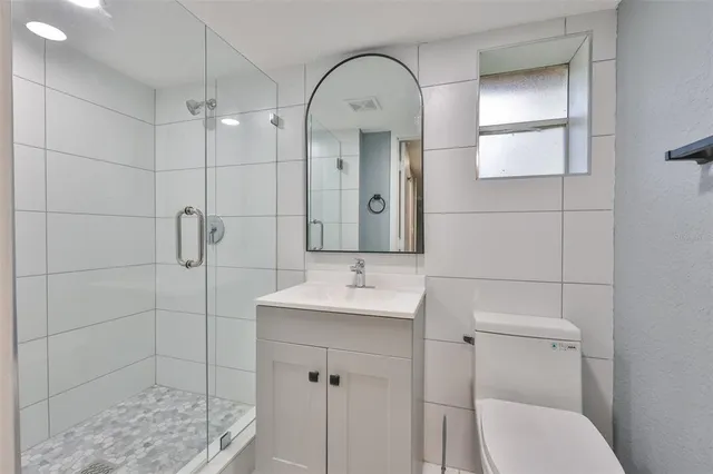 a bathroom with a sink toilet and shower