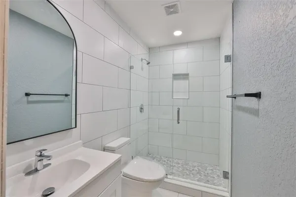 a bathroom with a sink toilet and shower