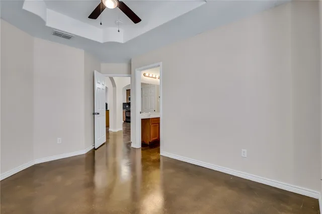 an empty room with a empty space and a ceiling fan