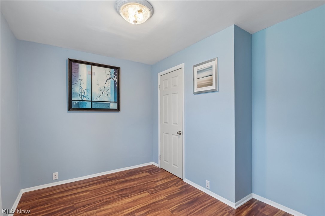 4188 Manchester Road Perry, OH 44081 - Photo 27 of 41 Wood-finish flooring with white trim and light blue walls