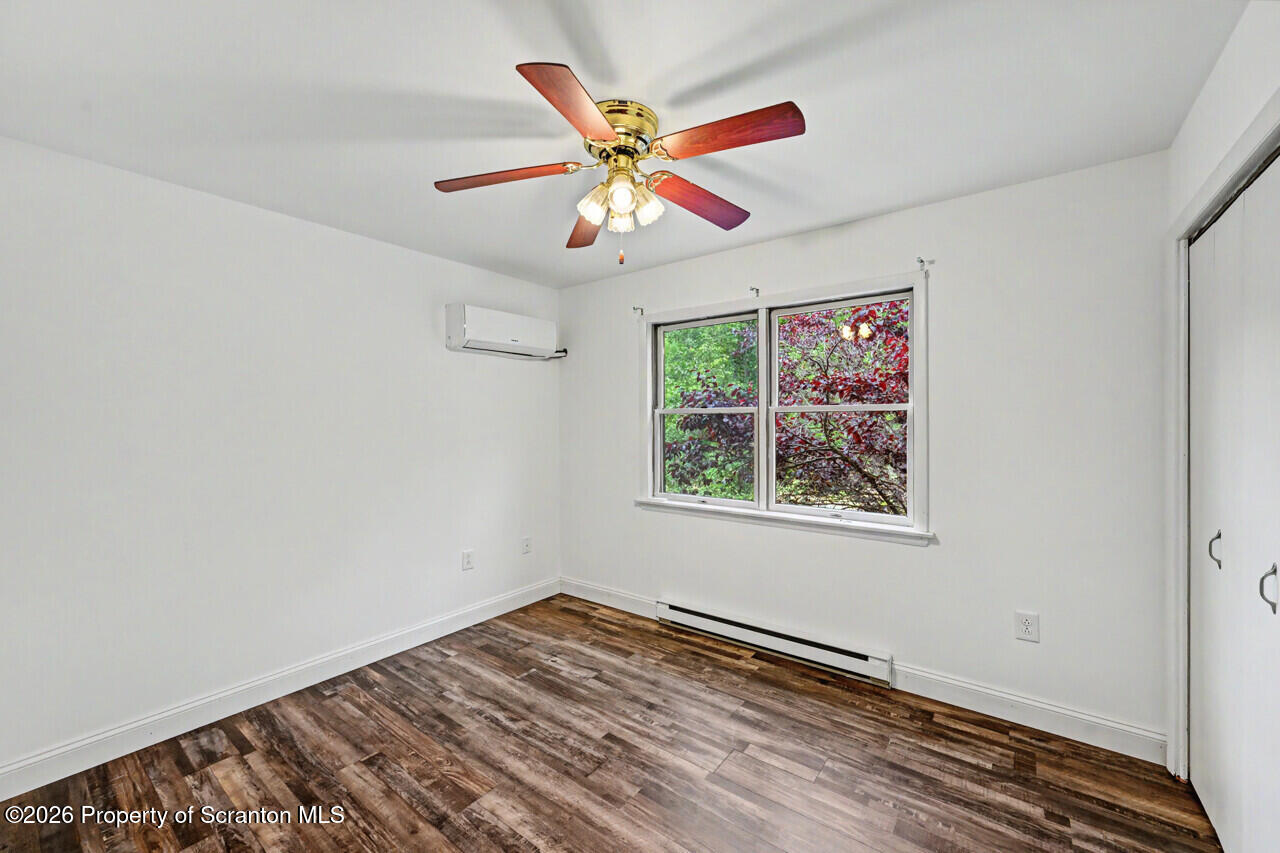 211 Buckingham Street Moscow, PA 18444 - Photo 51 of 83 a view of an empty room with window and a ceiling fan