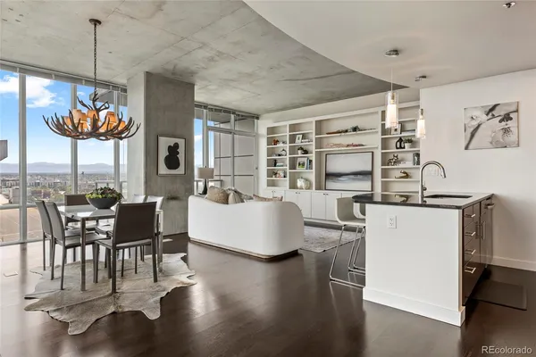 a dining room with furniture a chandelier and wooden floor