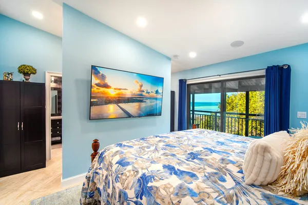 a bedroom with a bed and a large window