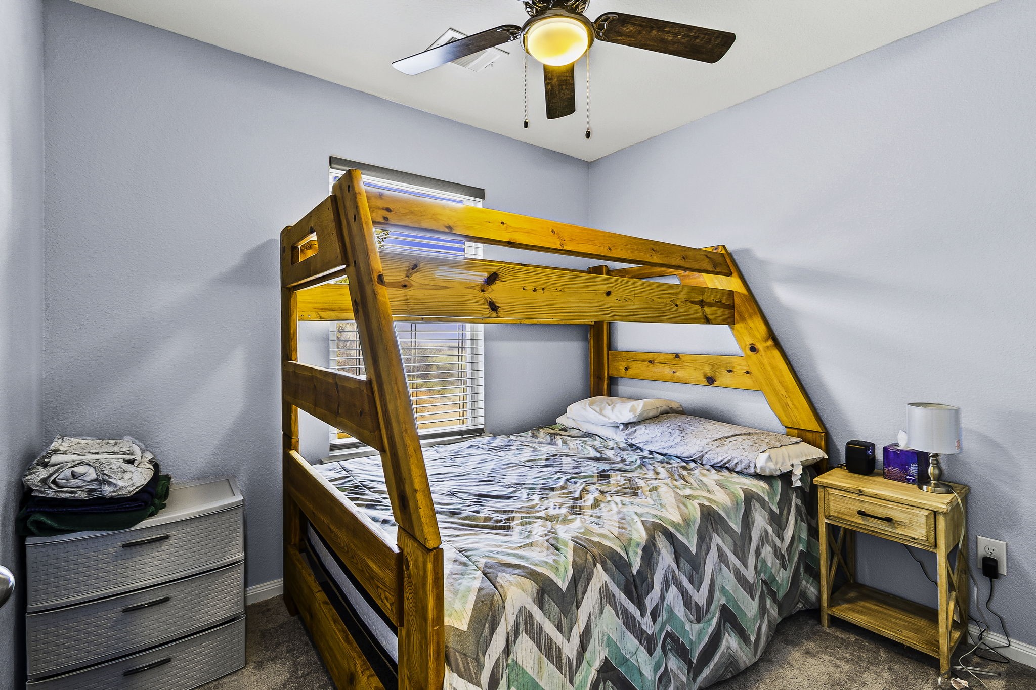 155 Cherry Tree Livingston, TX 77351 - Photo 11 of 30 a bedroom with a bed and a chandelier