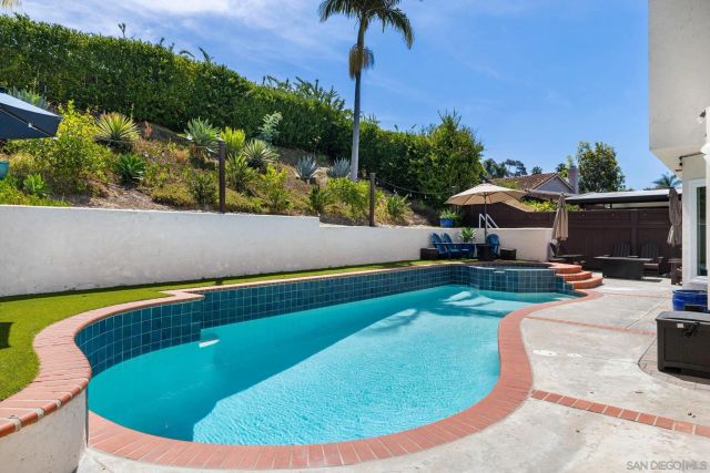 a swimming pool with outdoor seating and yard