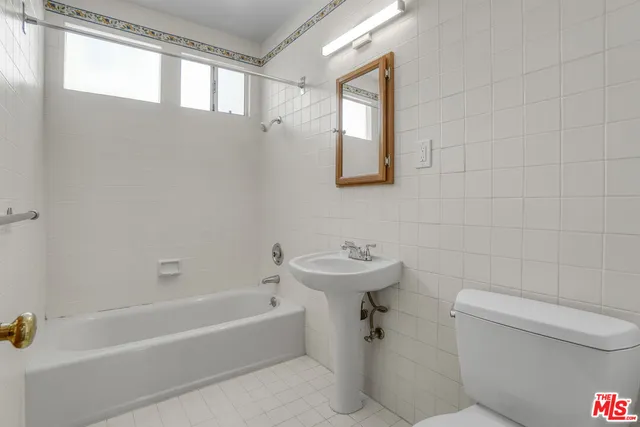a bathroom with a toilet a sink and bathtub