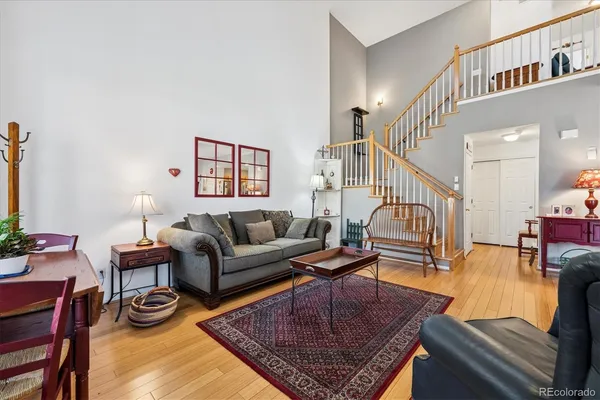 a living room with furniture a rug and a table