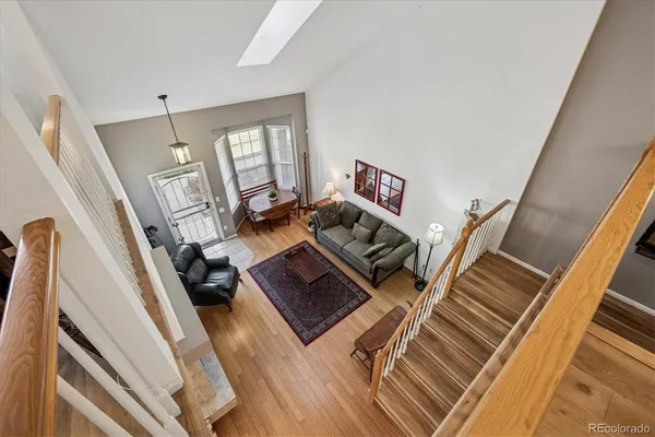 an empty room with windows and ceiling fan
